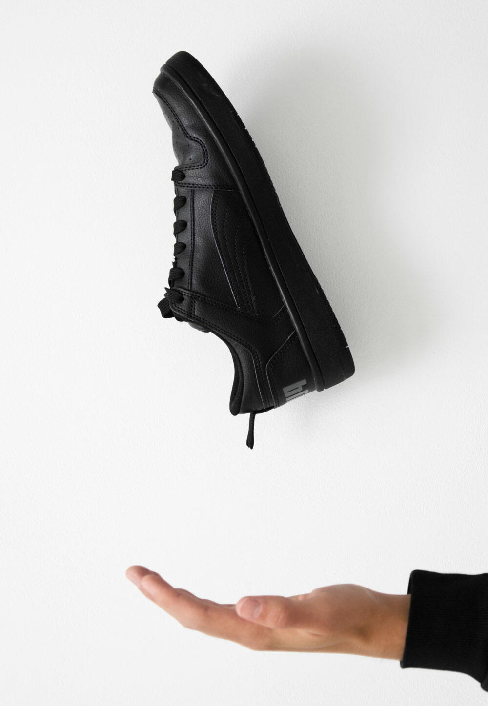 Pair of Black Shoes Hanging on a Wall (Demo)